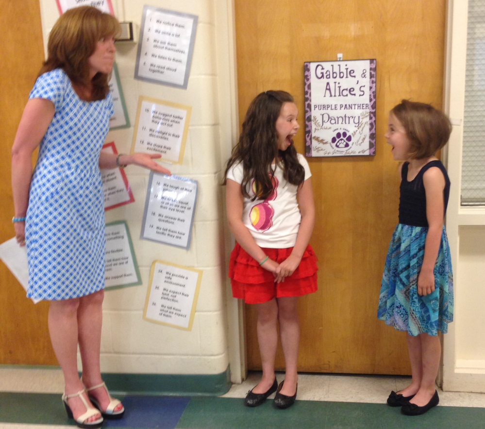 George J. Mitchell School students Gabbie St. Peter and Alice Willette react to news that a group that supports philanthropy by young people has awarded them $2,500 college scholarships.