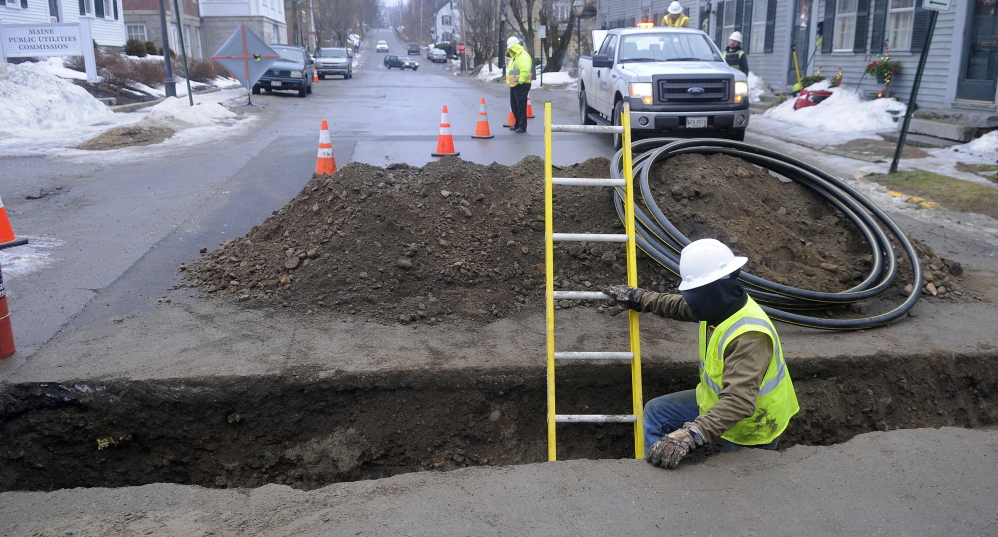 A contractor installs a distribution line last fall across Second Street in Hallowell for Summit Natural Gas of Maine.