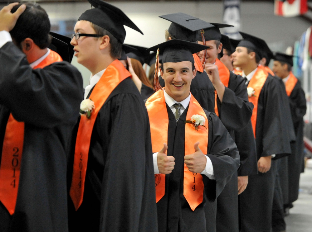 Staff photo by Michael G. Seamans READY TO GO: Winslow High School’s class of 2014 prepares for commencement ceremonies at the Alfond Athletic Center at Colby College in Waterville on Wednesday.