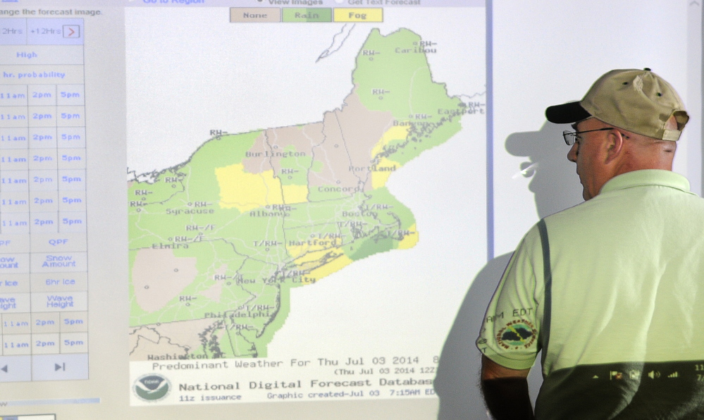Central Maine Pyrotechnics proprietor Steve Marson checks the weather Thursday while rescheduling fireworks shows his company was scheduled to shoot on the Fourth of July. Marson observes changes in the weather from several computer monitors at his Farmingdale office to determine how to plan shows.