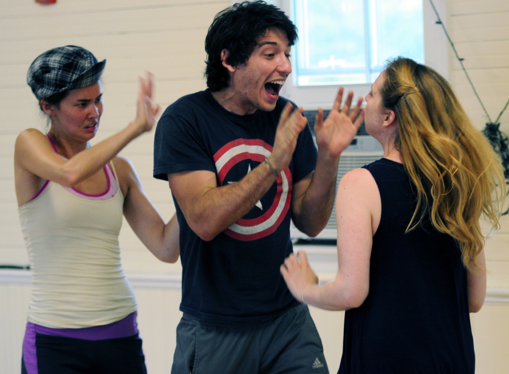 Erica Murphy (Rosalind), left, Leighton Samuels (Oliver) and Lindsay Tornquist (Celia) rehearse a scene from “As You Like It” in The Helen Melledy Grange in Monmouth.