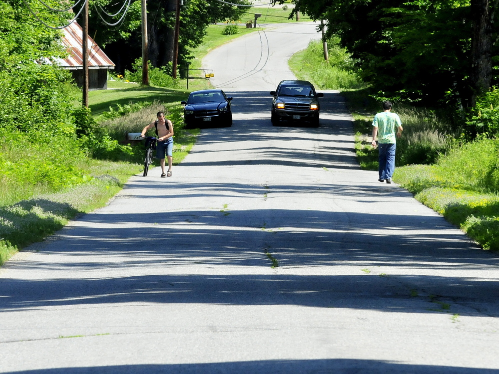 Though closed to all but local traffic, a pedestrian, cyclist and a motorist used the Morrison Hill Road in Farmington on Tuesday. The extremely rough road, named one of five worst roads in town, had a large culvert replaced as part of a major upcoming reconstruction.