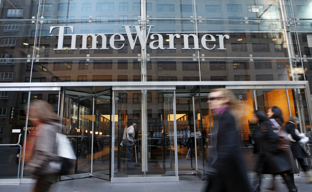 In this Nov. 7, 2007 file photo, people walk by the Time Warner Center in New York.