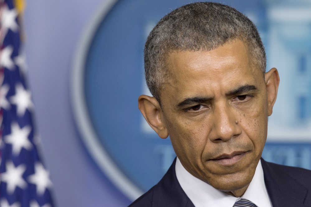 President Barack Obama pauses while speaking about the situation in Ukraine on Friday in the Brady Press Briefing Room of the White House in Washington.