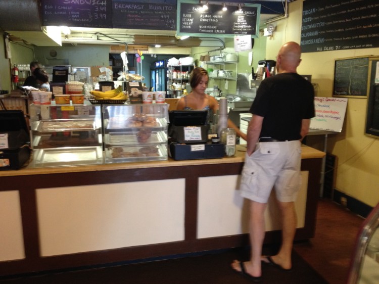 Morgan Guimond, of Jorgensen’s on Main Street, serves a customer Saturday morning. Guimond was one of several area business workers who said the 10-day long Maine International Film Festival boosted sales.