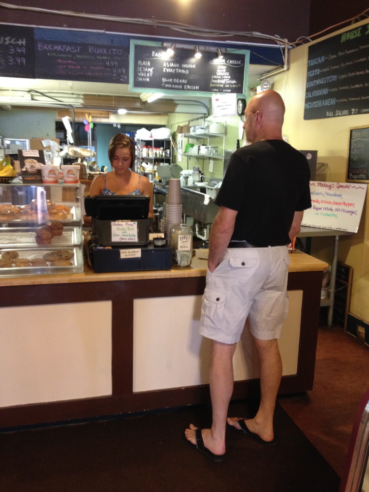 Morgan Guimond, of Jorgensen’s on Main Street, serves a customer Saturday morning. Guimond was one of several area business workers who said the 10-day Maine International Film Festival boosted sales.