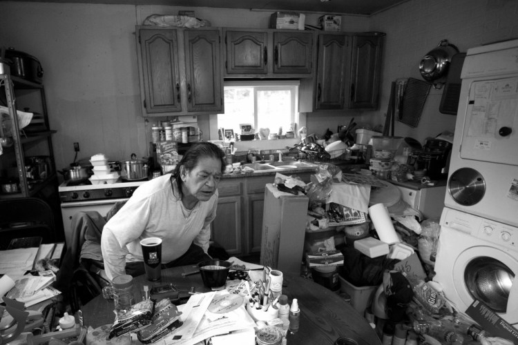 Richard Dana, aka “Stubby,” takes a seat in a wheelchair at his Indian Township home recently. Dana is disabled from an accident he had while working with steel at Bath Iron Works about 30 years ago. He now relies on elver fishing to eke out a modest living.