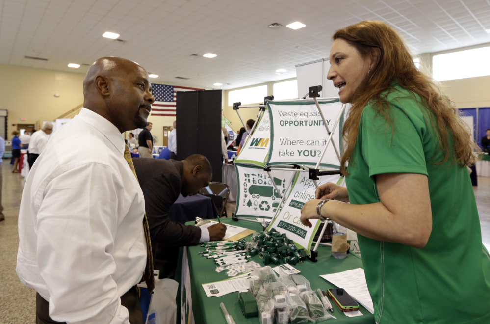 In this photo taken Wednesday, July 16, 2014, job seeker U.S. Air Force veteran Jimmie Walker, left, listens to job recruiter Desiree Akel, at a Hiring Fair For Veterans in Fort Lauderdale, Fla. (AP Photo/Alan Diaz)