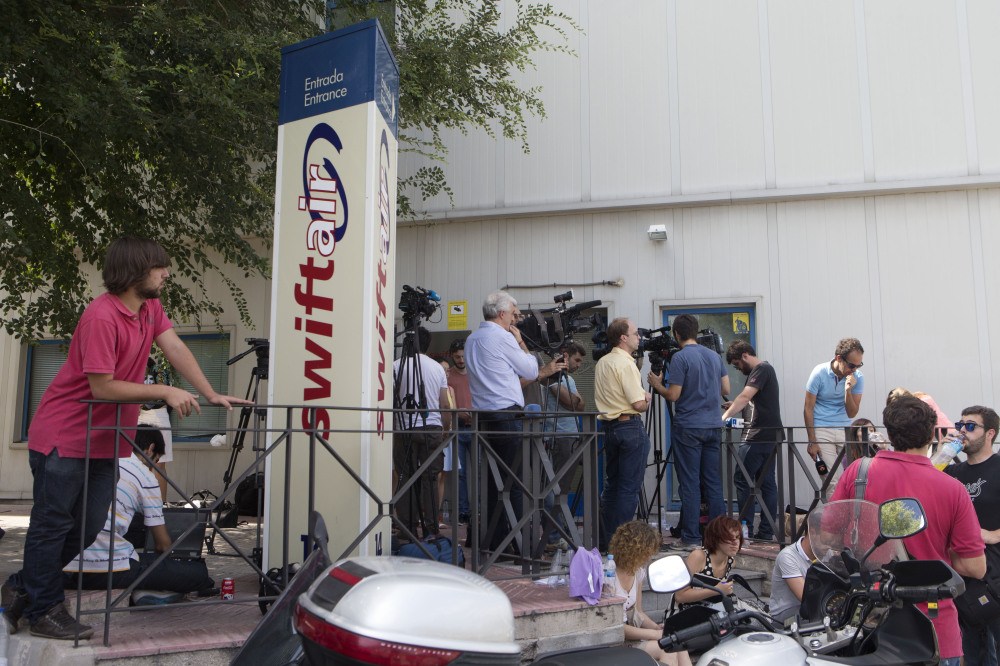 Journalists wait for news outside the Spanish Swiftair airline office in Madrid, Spain,Thursday. An Air Algerie flight carrying 116 people from Burkina Faso to Algeria’s capital disappeared from radar early Thursday over northern Mali The flight was being operated by Spanish airline Swiftair, the company said in a statement, and the plane belonged to Swiftair. The flight crew was Spanish.