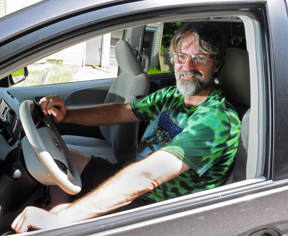 Steve Brown sits behind the wheel of his 2011 Toyota Sienna on Wednesday in Richmond. The van has a spinner steering wheel and a push right angle handle to control acceleration and stopping.