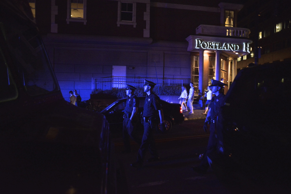 Police patrol the street after 1 a.m. Sunday, July 6, after the Independence Day weekend celebration in downtown Portland.