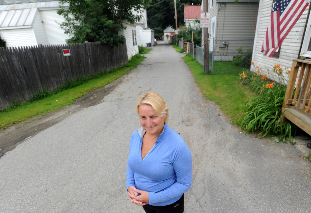 City Councilor Karen Rancourt-Thomas, D-Ward 7, stands outside her residence on Carey Lane on Friday. Rancourt-Thomas said some foreclosed-on homes in the neighborhood should be torn down, not sold, in order to stem a rising crime problem.