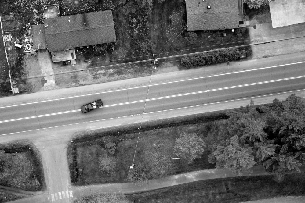 A pickup truck negotiates a turn along “the strip” on Route 1 in Indian Township reservation recently.