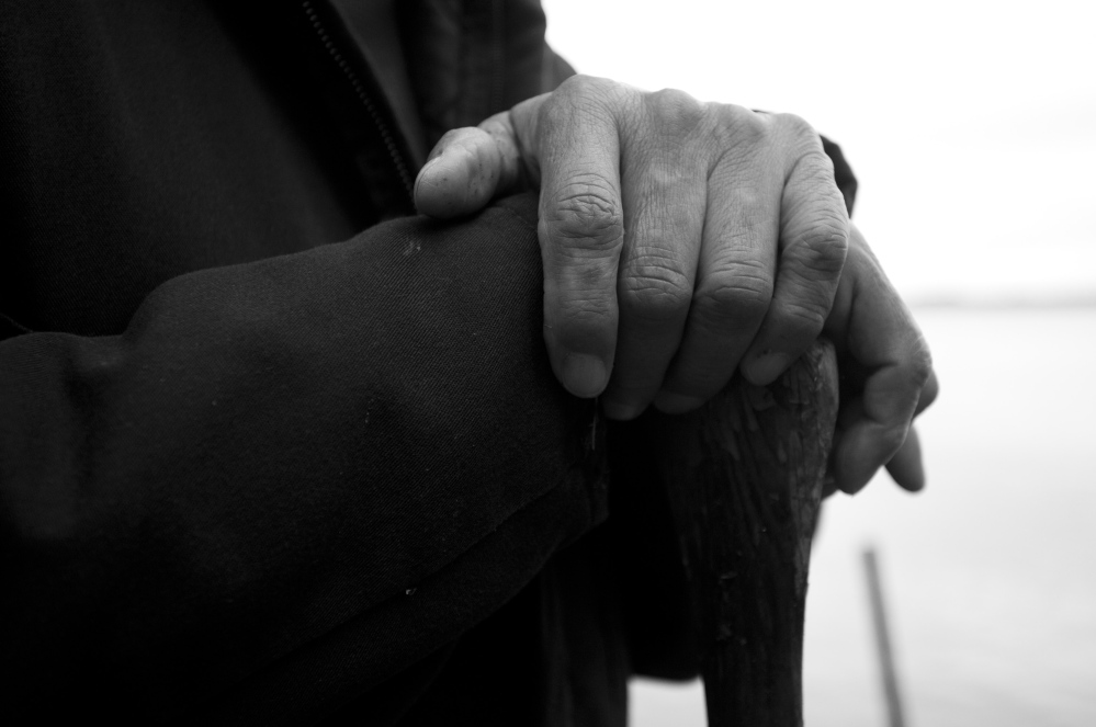 A Passamaquoddy elder rests his hands on an oar while working at his camp on Long Lake in Indian Township this spring. The people on the tribe’s two eastern Maine reservations have spent decades fighting for their rights while struggling to preserve their collective identity.