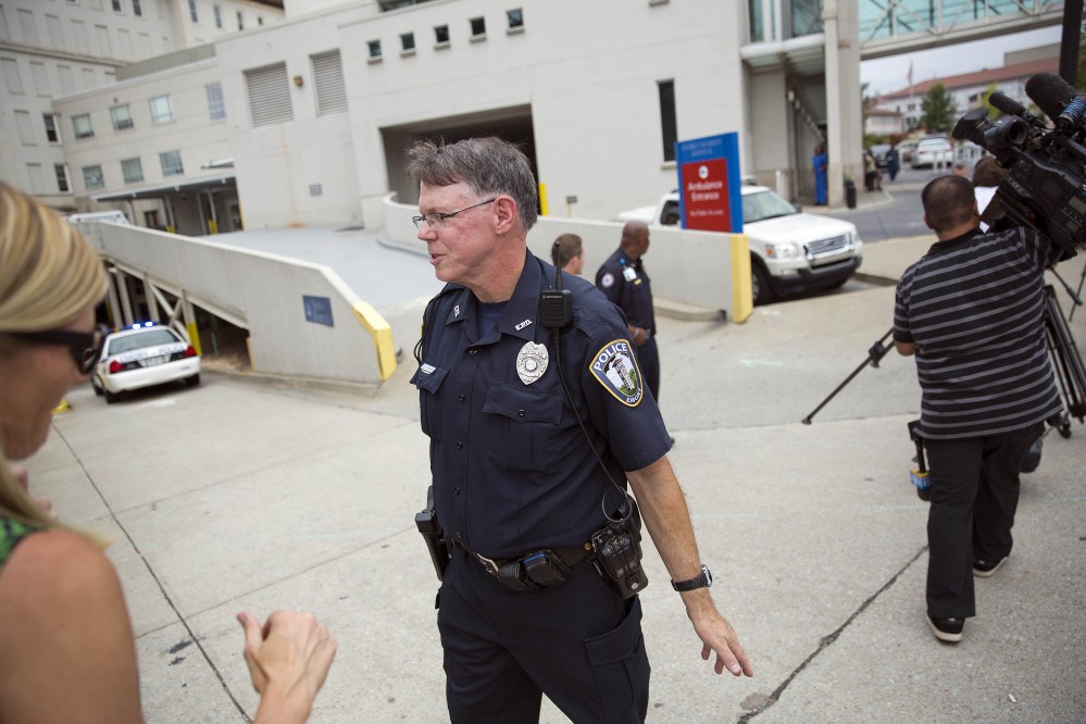 A police officer clears an entrance to Emory University Hospital in Atlanta, Ga. after an ambulance arrived transporting an American that was infected with the Ebola virus.