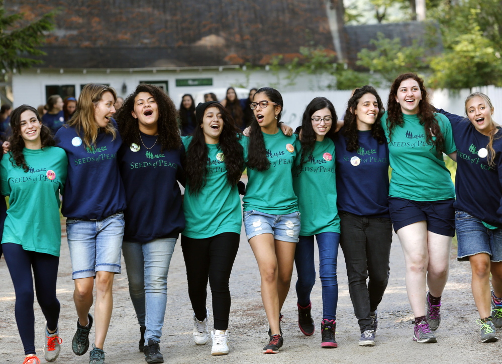 Campers join arms and sing songs as they make their way to opening ceremonies at Seeds of Peace.