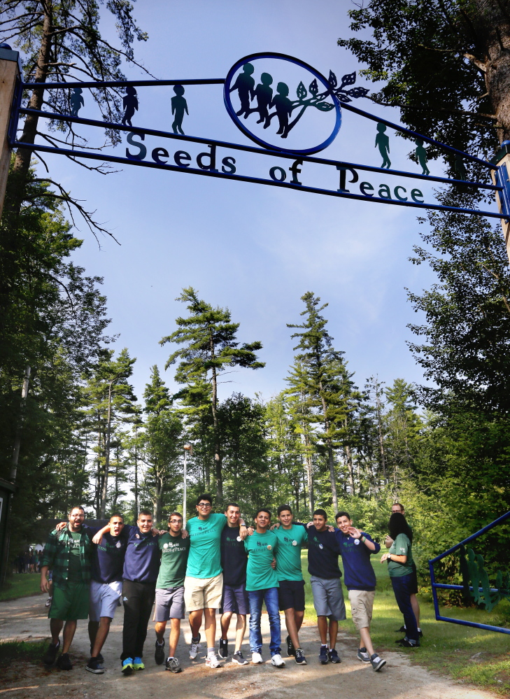 A group of campers join arms and sing songs as they make their way to opening ceremonies at Seeds of Peace.