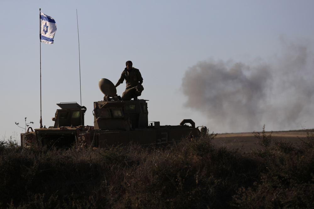 An Israeli solder looks on the site near the Israeli Gaza border, where a man was injured from a mortar shell fired from the Gaza Strip, Sunday.