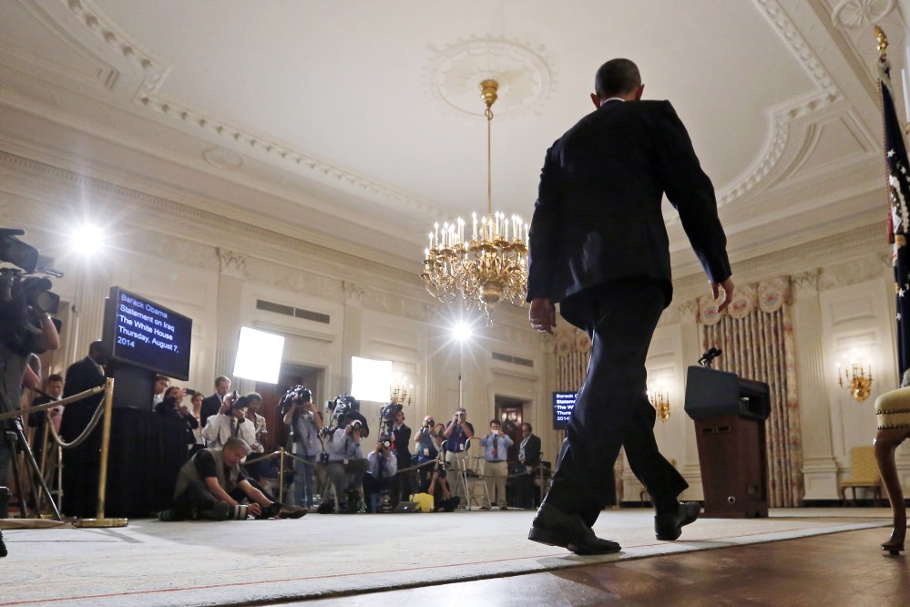 President Barack Obama approaches the podium to speak about the situation in Iraq in the State Dining Room at the White House in Washington.