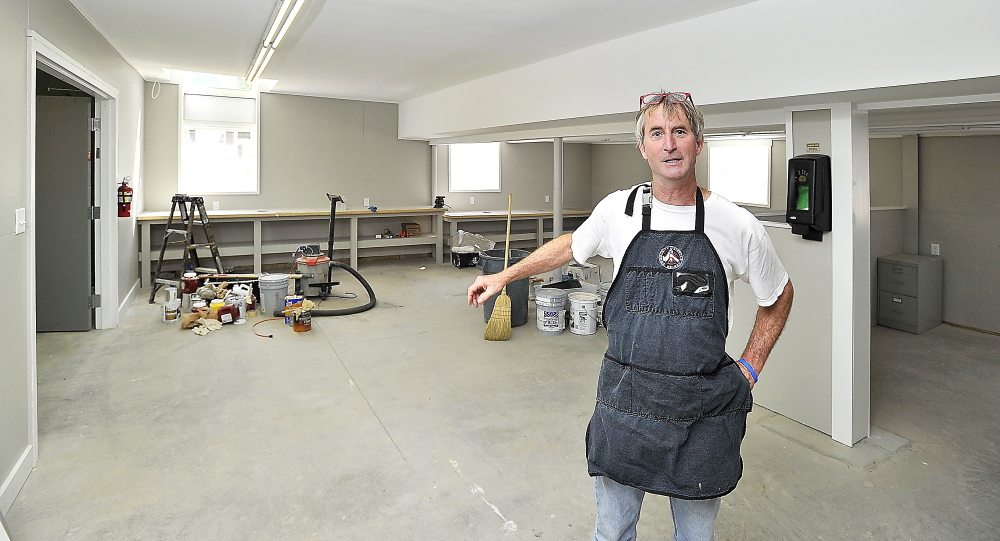 Above, Community Bicycle Center Executive Director Andy Greif points out the spacious interior of the building that will house the nonprofit program in Biddeford starting in September. At top, the new center’s exterior is shown.