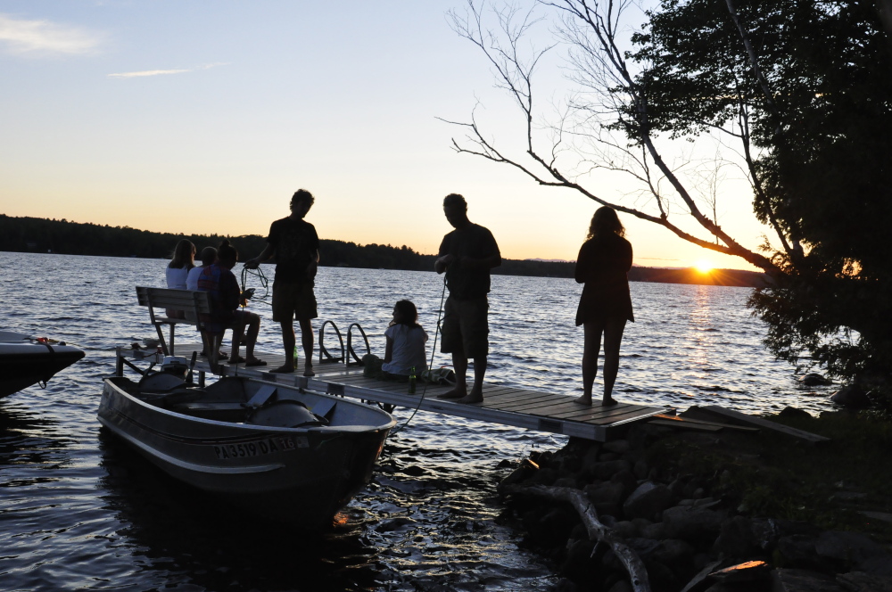 Contributed photo 
 A group of friends gather to watch the sunset on Wesserunsett Lake recently.