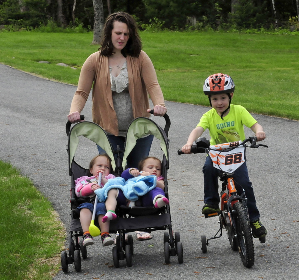 Emily Walker with her children two weeks after twin 2-year-old daughters, Maddilyn, left, and Brooklyn were hurt in what police charge was a beating administered by David Devine, Walker’s boyfriend. Brother Wyatt, 4, tags along.