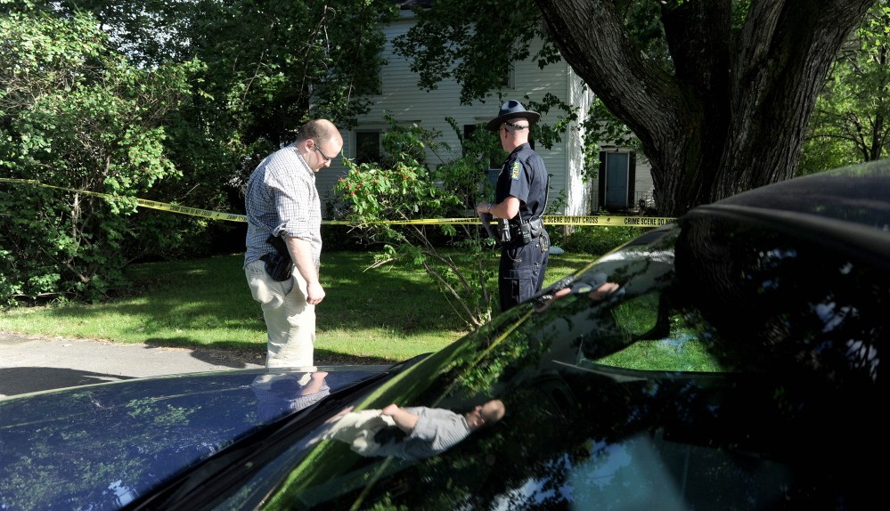 Skowhegan police officers stand outside 23 Chestnut St. after resident Wayne Shaw was seriously injured by another man on Thursday, police said.