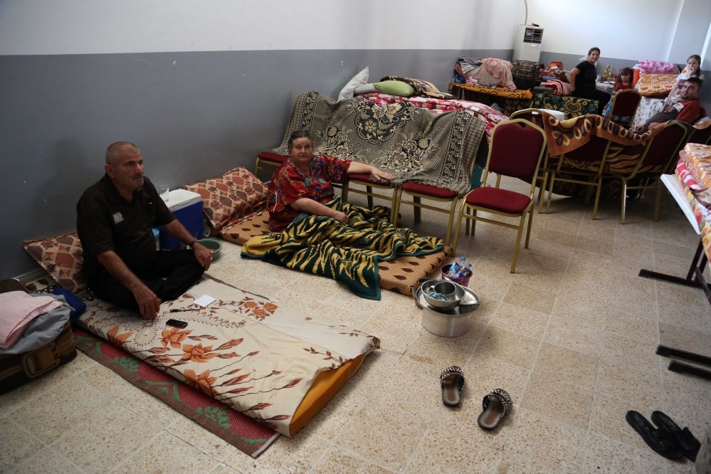 Displaced Iraqi Christians and Yazidis settle at diocese of Zakho, 300 miles (475 kilometers) northwest of Baghdad, Iraq, Saturday.