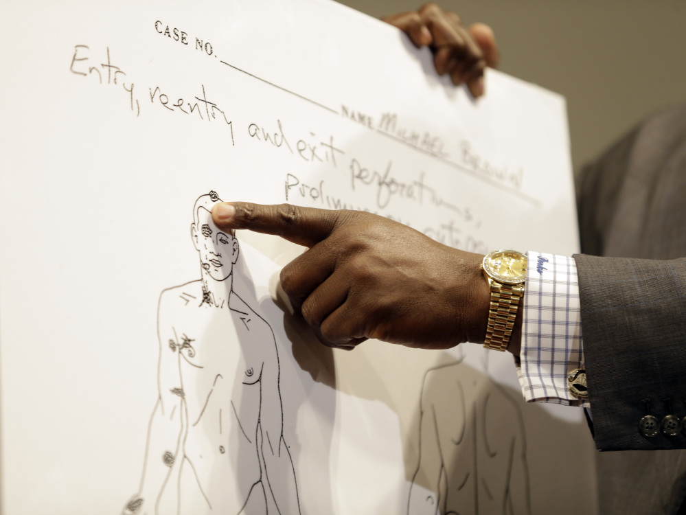 Brown family attorney Daryl Parks points to a diagram produced during a second autopsy done on Michael Brown, Monday, in St. Louis County, Mo.