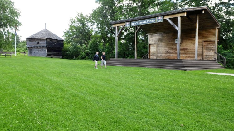 Nancy Gaunce, left, and Millie Meers walk in Fort Halifax Park in Winslow between the historic fort building and the Mary Simcock pavilion. Plans are underway to restore the fort to its original setting, install walkways and relocate the parking area.