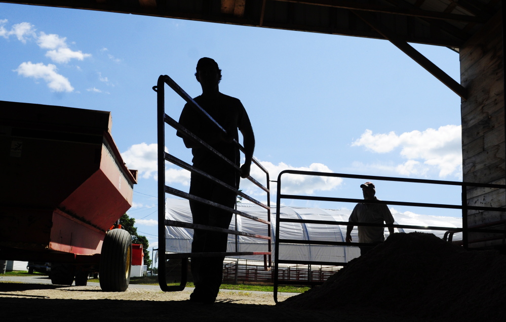 A.J. Larrabee, left, and John Perkins move fence sections around a sheep barn on Tuesday as they set up for the Windsor Fair that opens Sunday. The fair runs from Sunday through Sept. 1 at the Windsor Fair Grounds on Ridge Road (Route 32).