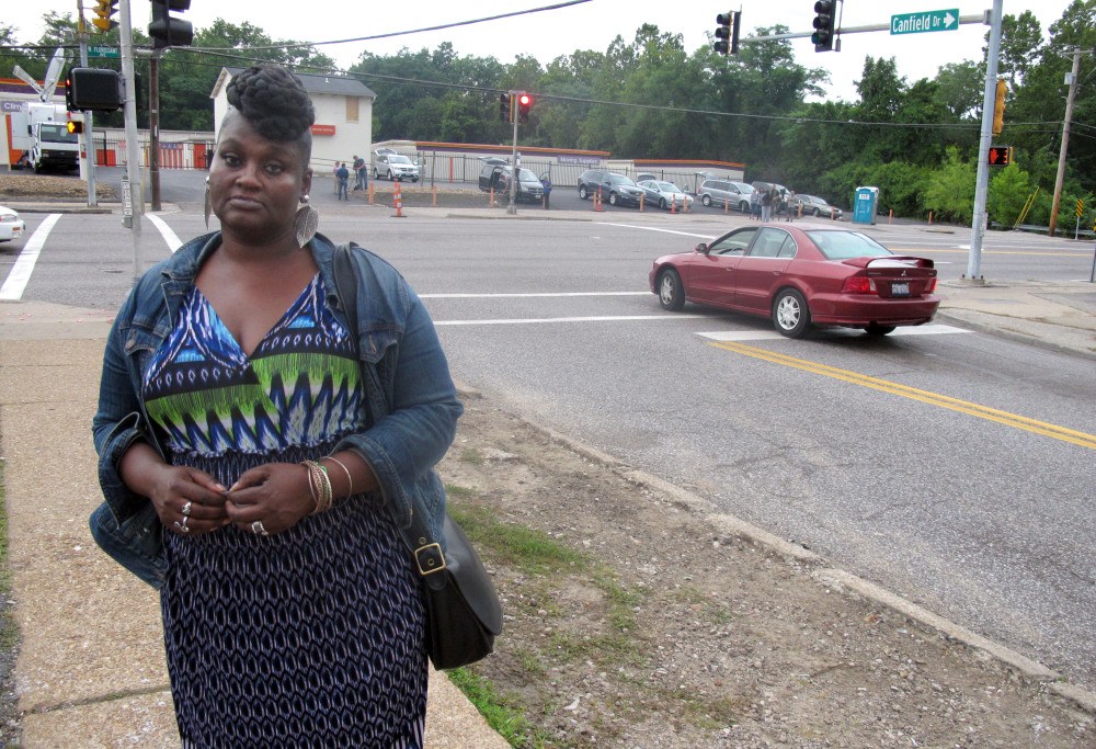 Angelia Dickens, 55, poses for a photo on Canfield Drive in Ferguson, Mo. The area has been the site of unrest since the Aug. 9 police shooting of unarmed 18-year-old Michael Brown. Dickens says she’s been unable to work her night job because of street closures and is ready for the chaos to “die down.”