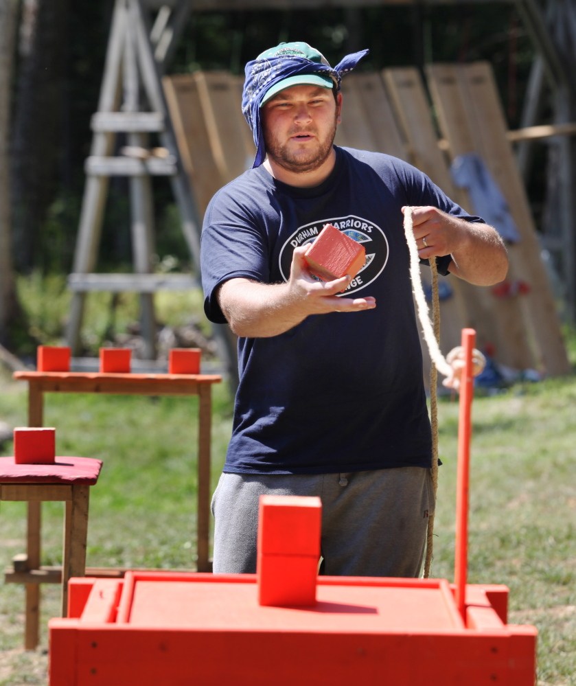 Ian Szechowycz, of Macomb, Illinois, competes in a tilting table event Sunday during the 2nd annual Durham Warriors Survival Challenge in Durham. Participants must stack blocks on top of the table while keeping it balanced.