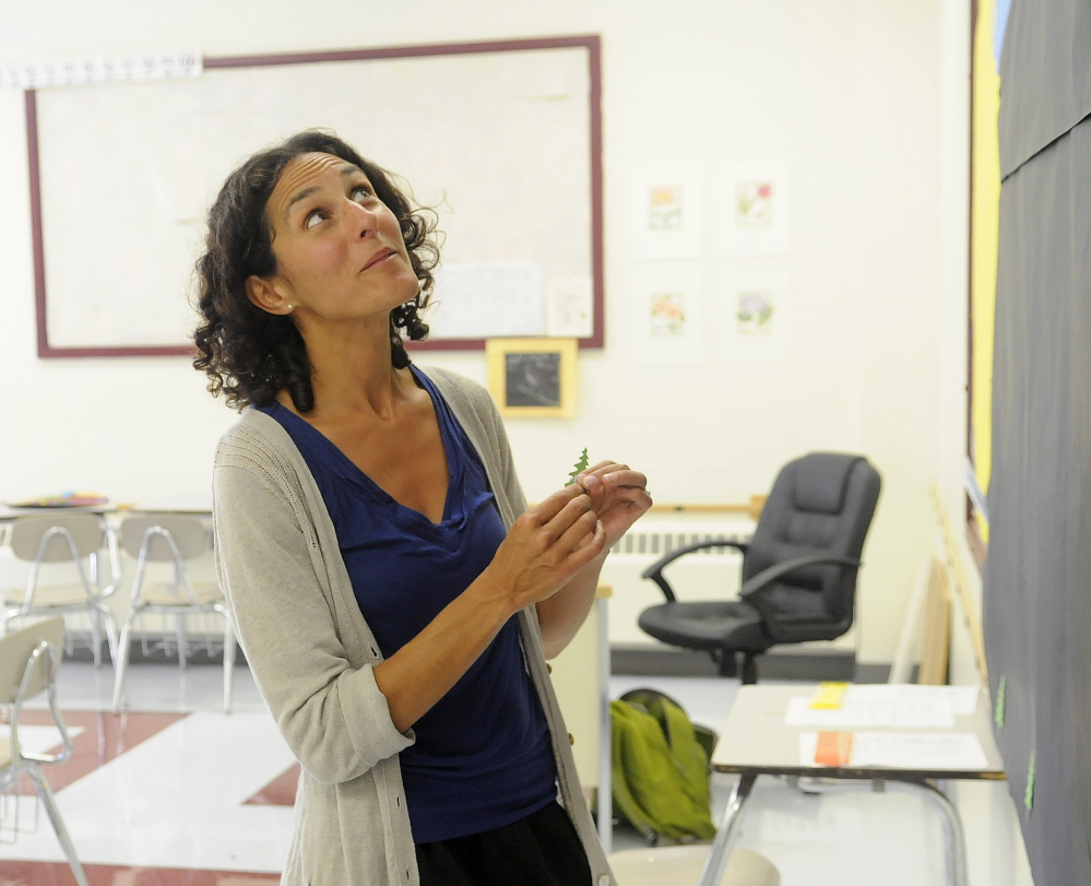 Jessica Viselli decorates her classroom Monday at the Richmond Middle School. Viselli is starting her first year as a teacher in her home town.