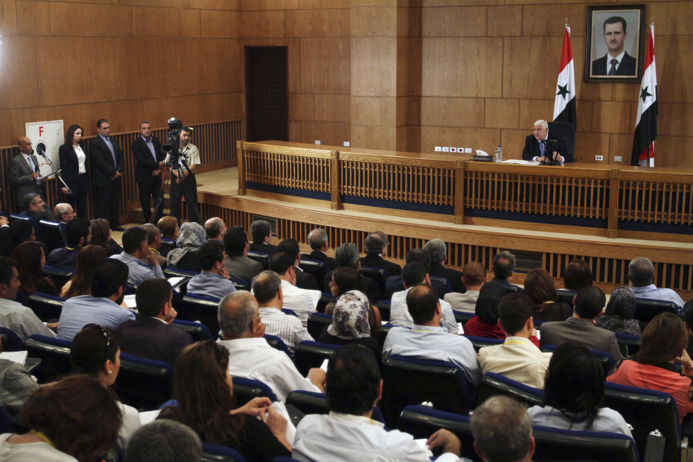Syrian Foreign Minister Walid al-Moallem speaks during a press conference, giving the first public comments by a senior Assad official on the threat posed by the Islamic State group, in Damascus, Syria on Monday.