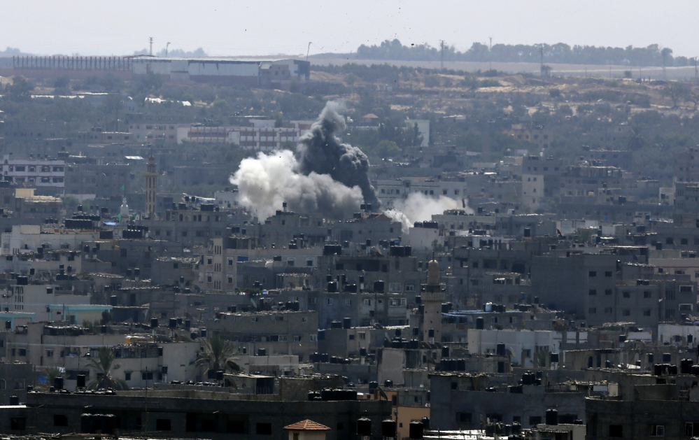 Smoke and dust rise after an Israeli strike hits in Gaza City, northern Gaza Strip, Tuesday.