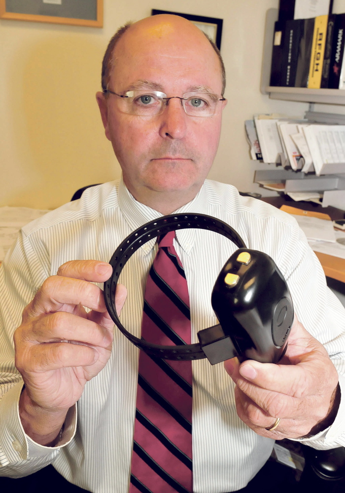 Chief Deputy Dale Lancaster of the Somerset County Sheriff Office with a tracking device that can be used to monitor the location of people charged with domestic assault.