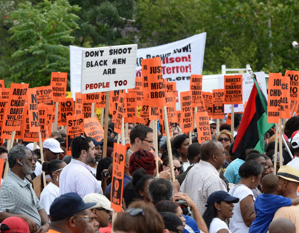 Demonstrators gather for a rally in Ferguson, Mo., on Saturday near the site where Michael Brown, an unarmed black 18-year-old, was fatally shot by a white police officer three weeks earlier.