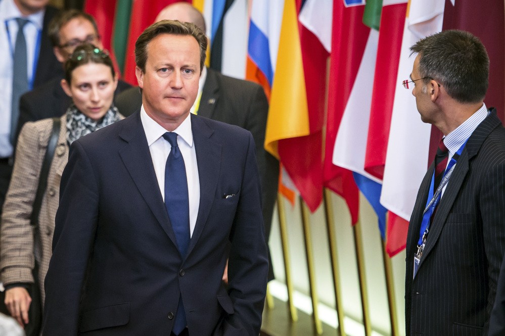 British Prime Minister David Cameron leaves the EU Council building at the end of an EU summit in Brussels, early Sunday.