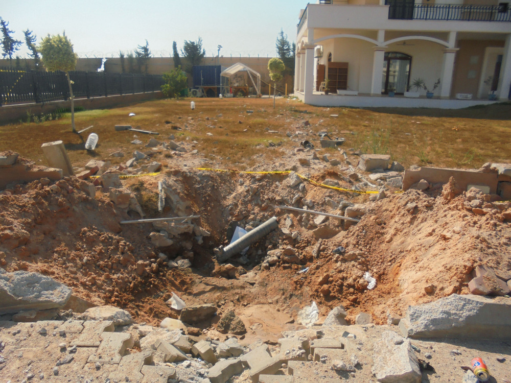 In this photo taken during a tour offered to onlookers and journalists by the Dawn of Libya militia on Sunday, damage is seen in the front yard of a building at the U.S. Embassy compound in Tripoli, Libya, after weeks of violence between rival militias over control of the capital.