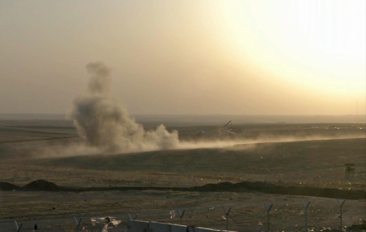 Smoke rises from airstrikes targeting Islamic State militants outside of the city of Irbil in northern Iraq, on Friday. The Associated Press via AP video