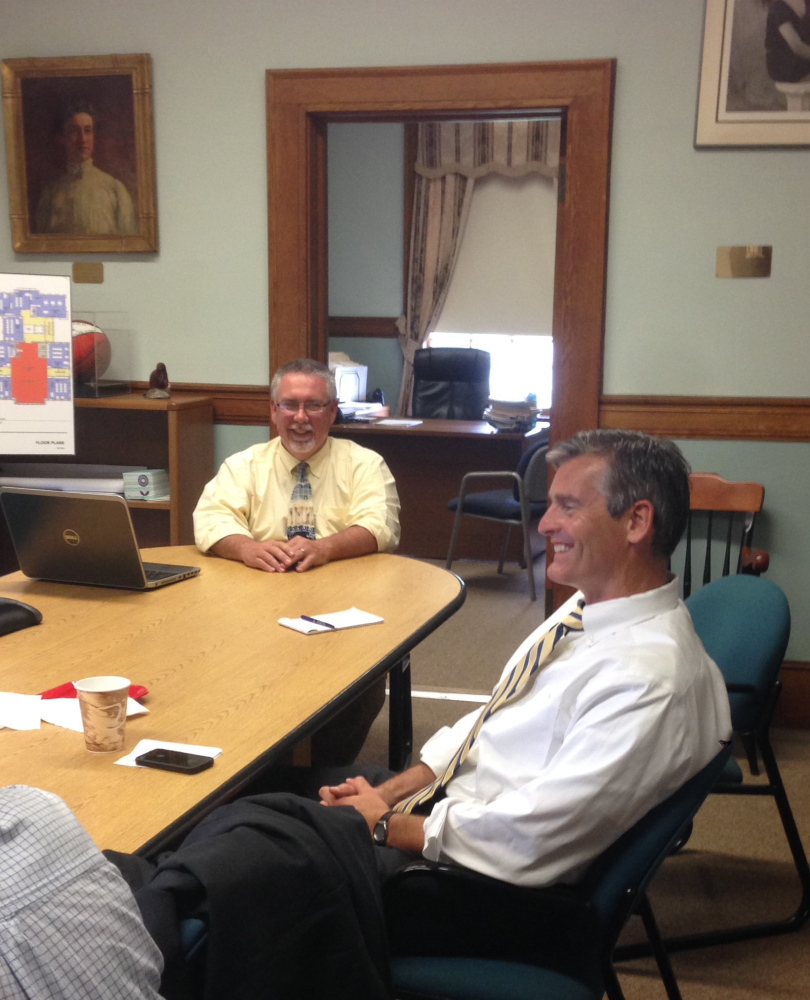 Glenn Cummings, newly appointed interim president of the University of Maine at Augusta, speaks with staff members at Good Will-Hinckley, where he served as president and executive director. Robert Moody, rear, who has been the institution’s vice president of operations, is part of a team of four administrators who will manage the school through the transition to new leadership.