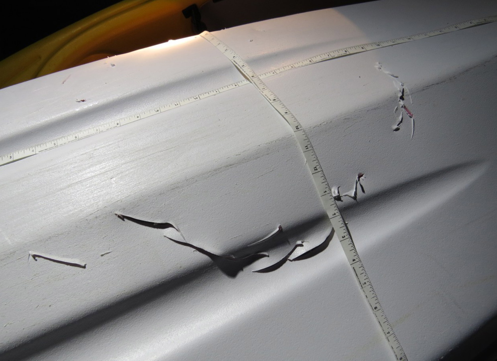 Photo from the Massachusetts Division of Marine Fisheries shows holes in a kayak that an agency expert says were made by a bite from a great white shark off Plymouth, Mass.
