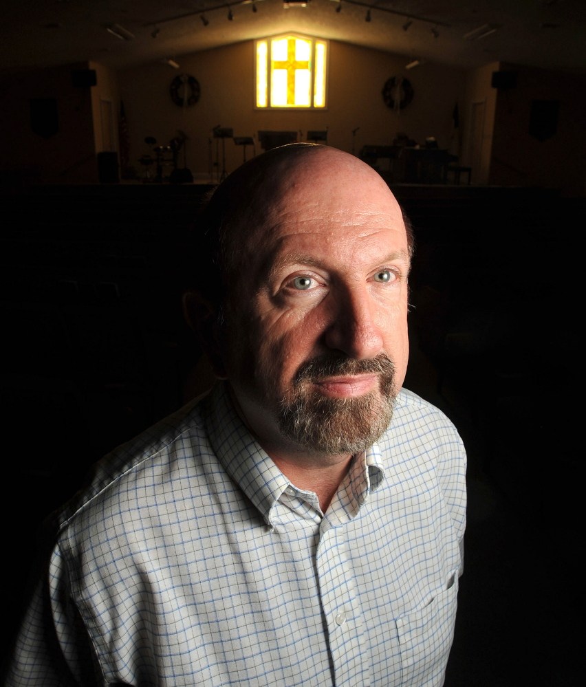 Pastor Richard Haynie stands in the chapel of the Open Bible Church in Athens. The church celebrates its 50th anniversary this weekend.