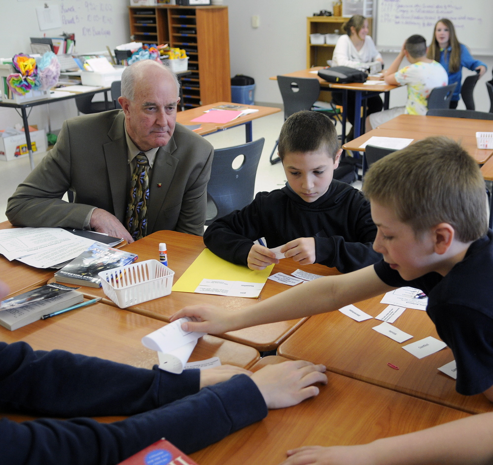 Education Commissioner Jim Rier observes Cony High School seventh-graders earlier this year as they work on a language arts problem at the Augusta school.