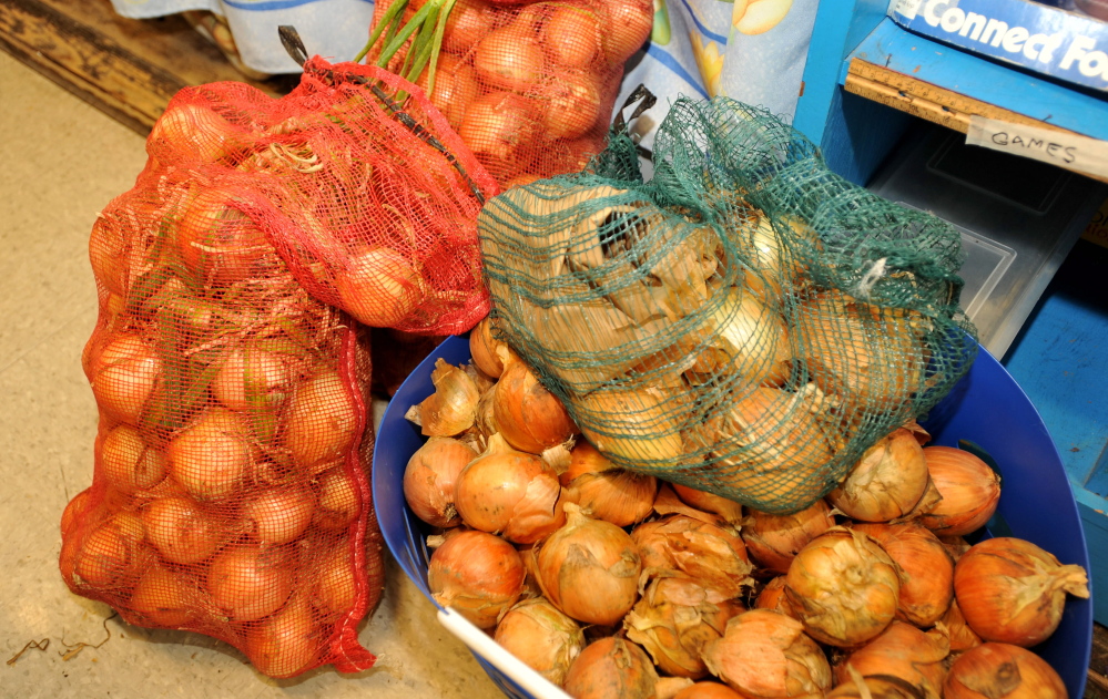 Sacks of donated onions wait for distribution at Albert S. Hall School in Waterville on Wednesday,