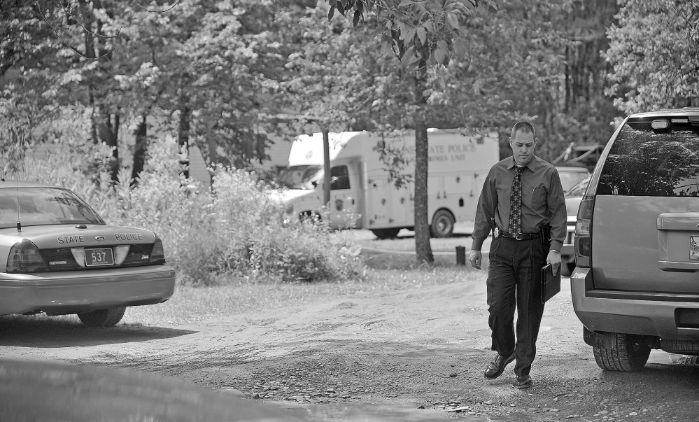 Maine State Police investigate in July 2013 at the home of murder victim Ricky Cole, 47, at 24 Main St. in Detroit.