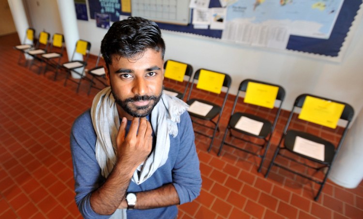 Aquib Yacoob stands in front of an exhibit at Colby College of 10 empty chairs representing minority individuals who have been killed by police across the country. Yacoob, a Colby College senior, spent two weeks in Ferguson, Mo., with Amnesty International and the United Nations in the aftermath of the police shooting of an unarmed black man.
