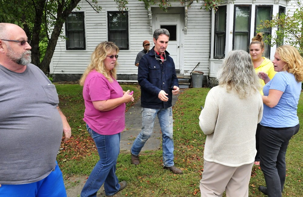 Mike Wolfe, center, a co-host for the reality TV program “American Pickers,” signs autographs and poses for pictures with fans outside 11 Pleasant St. in Skowhegan, where the show went to buy antiques.