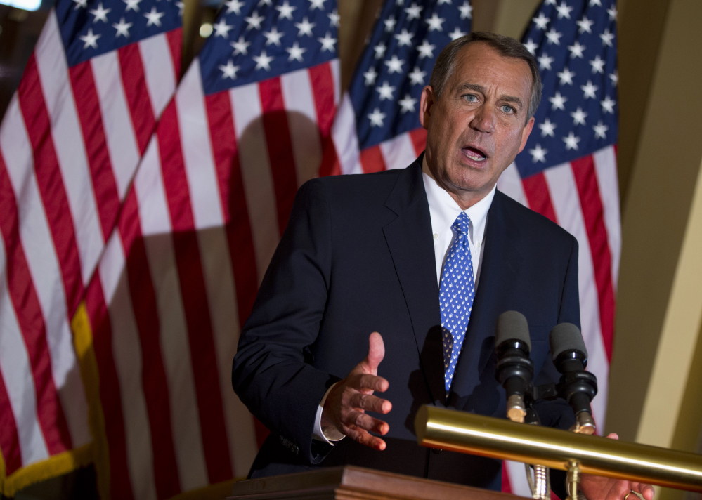 House Speaker John Boehner of Ohio gestures while speaking outside his office on Capitol Hill in Washington in this 2013 photo.